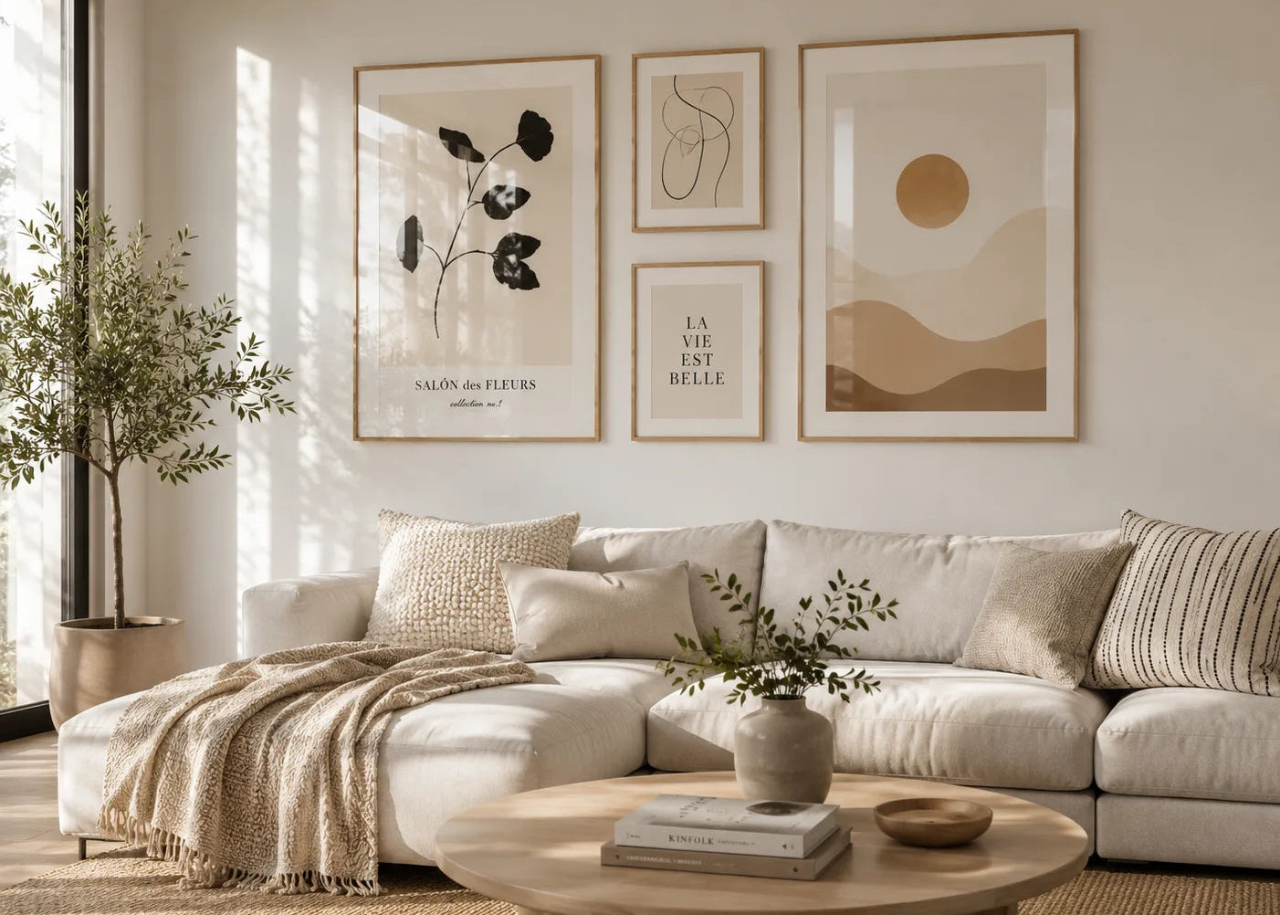 Modern gallery wall with framed posters above a beige sofa in a bright Scandinavian living room